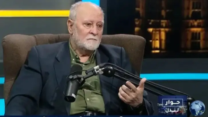 A person sitting in a chair with a microphone

Description automatically generated